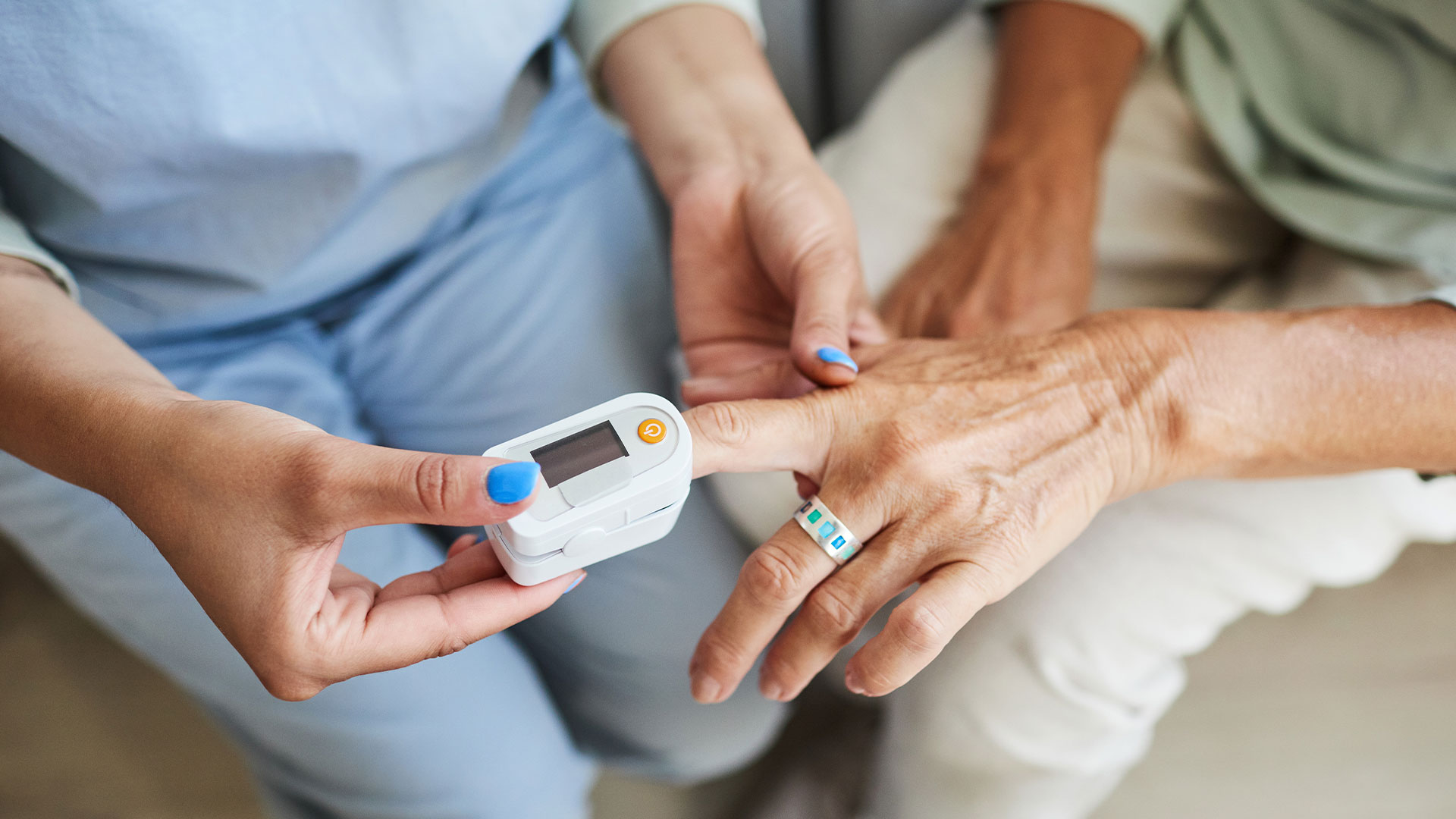 nurse checking patients heart at home