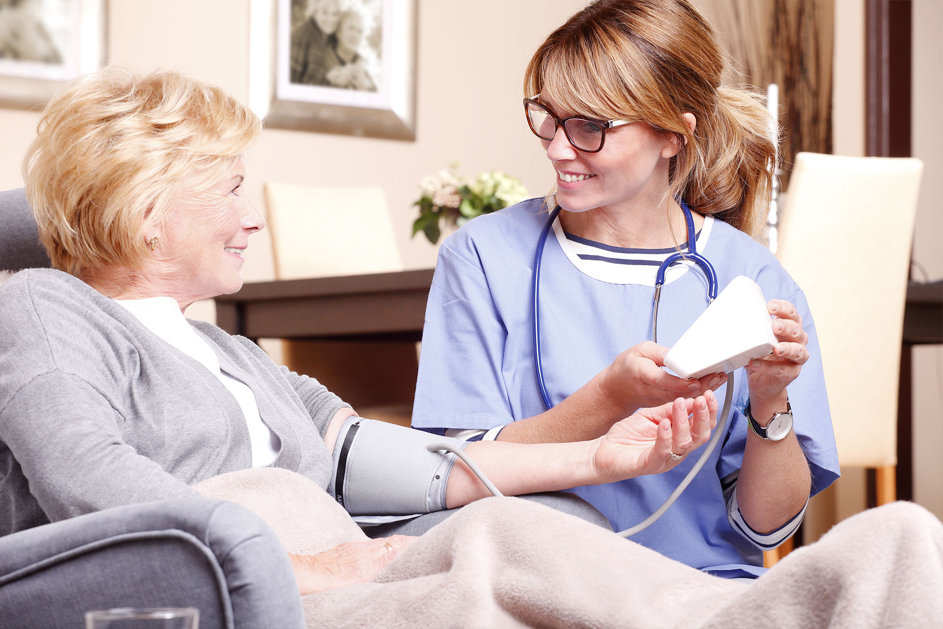 Nurse helping patient understand how to read blood pressure machine