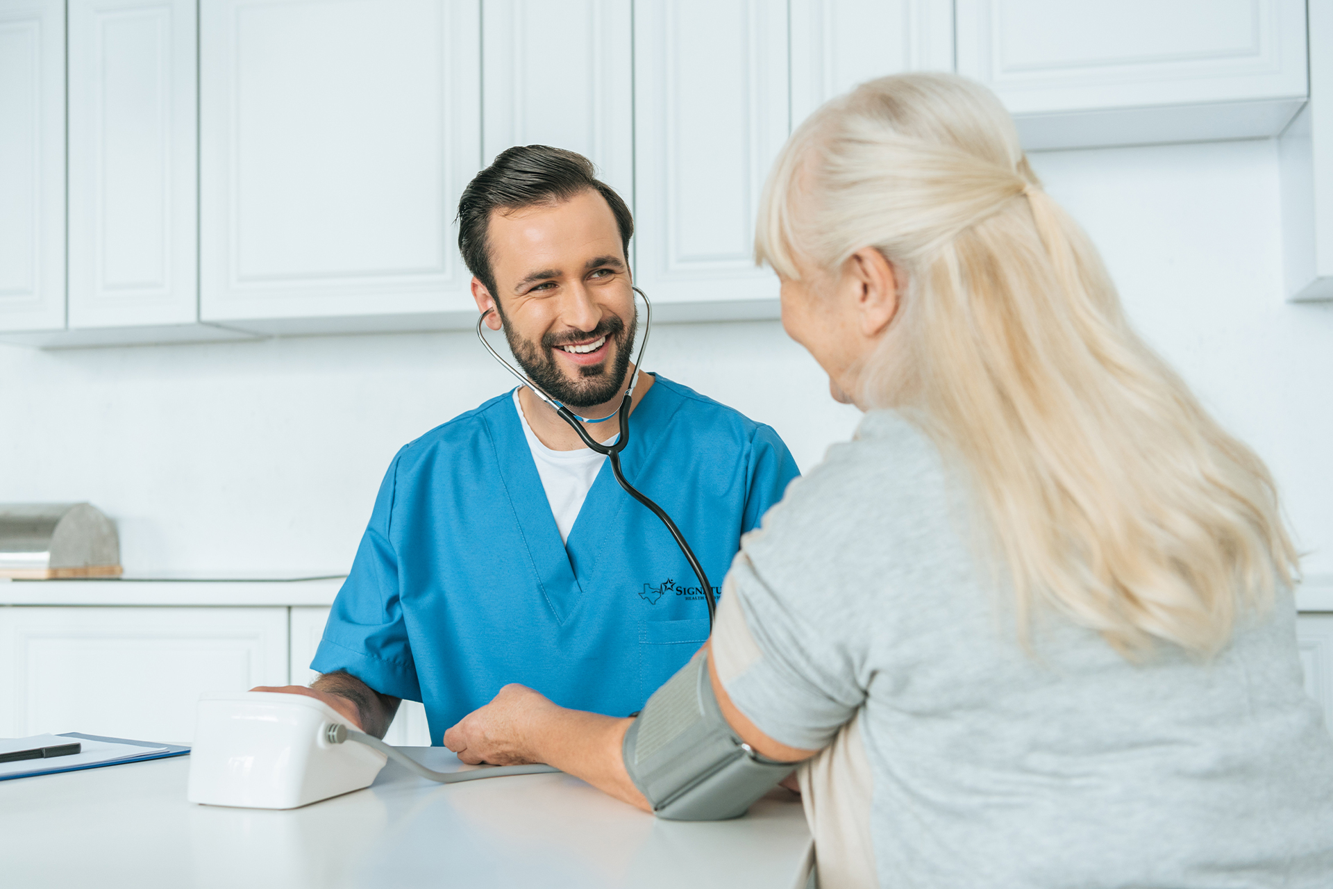 Male nurse taking patient's blood pressure