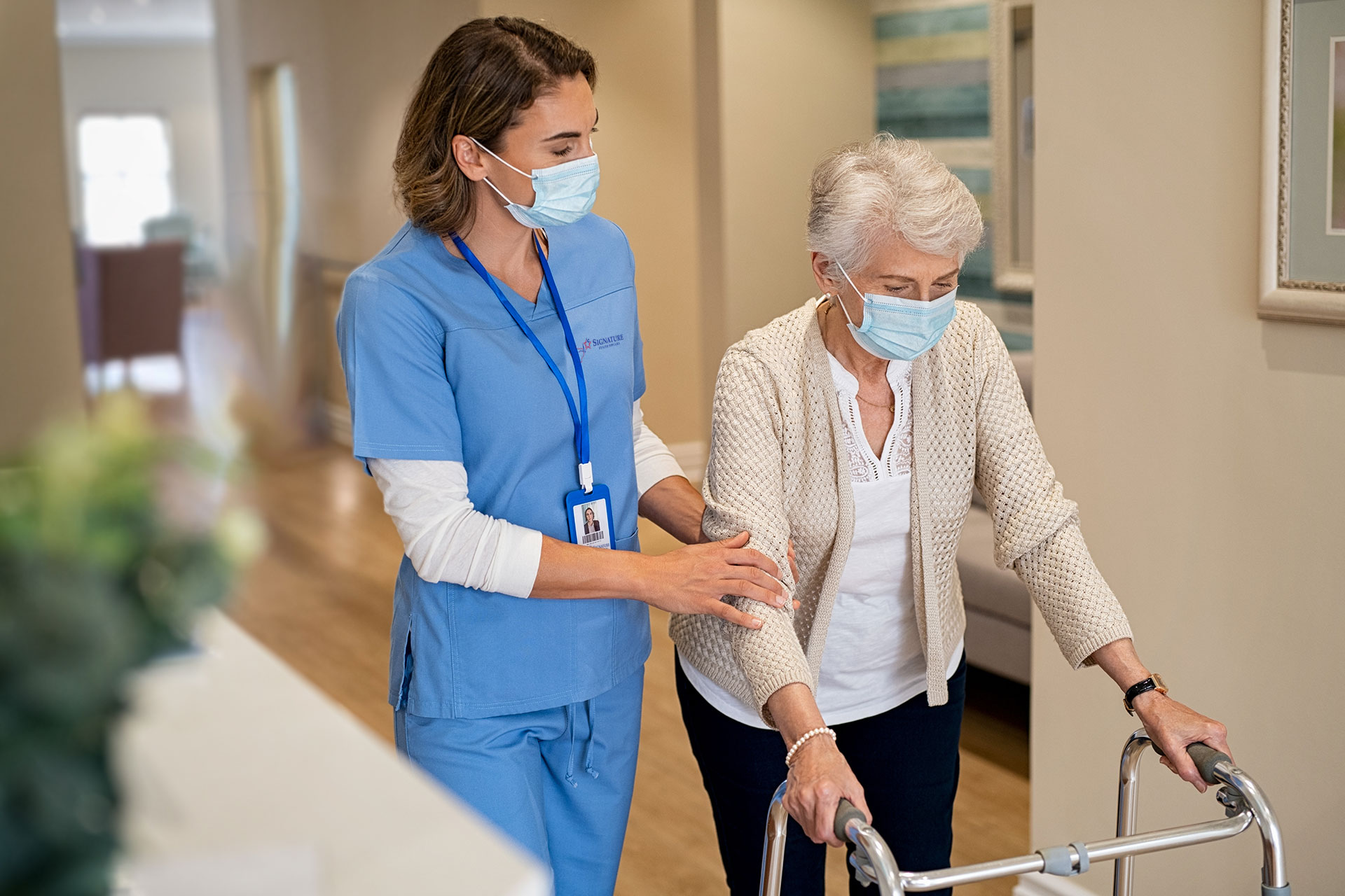 nurse helping female patient walk