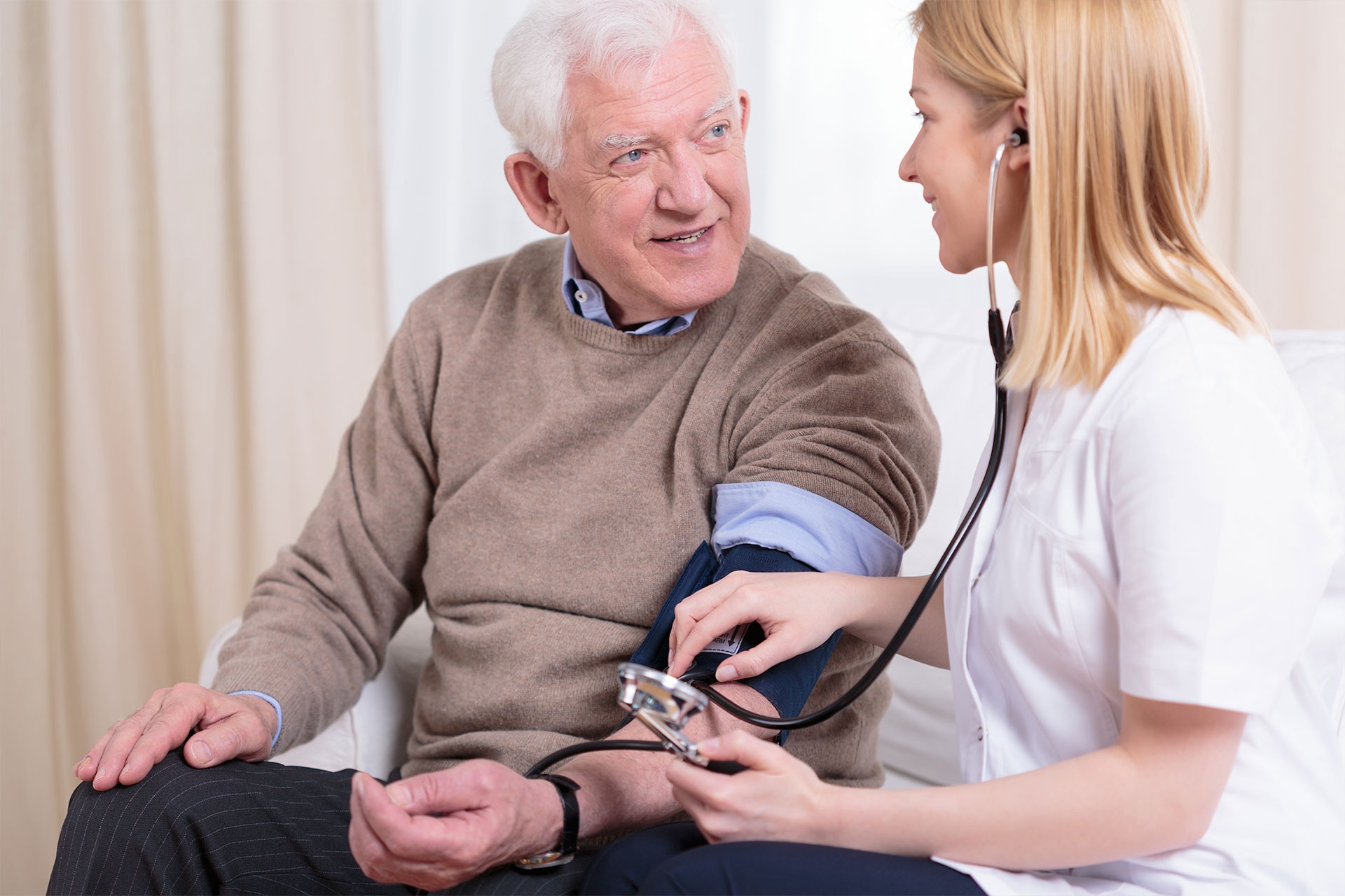 nurse caring for patient by checking for high or unhealthy cholesterol