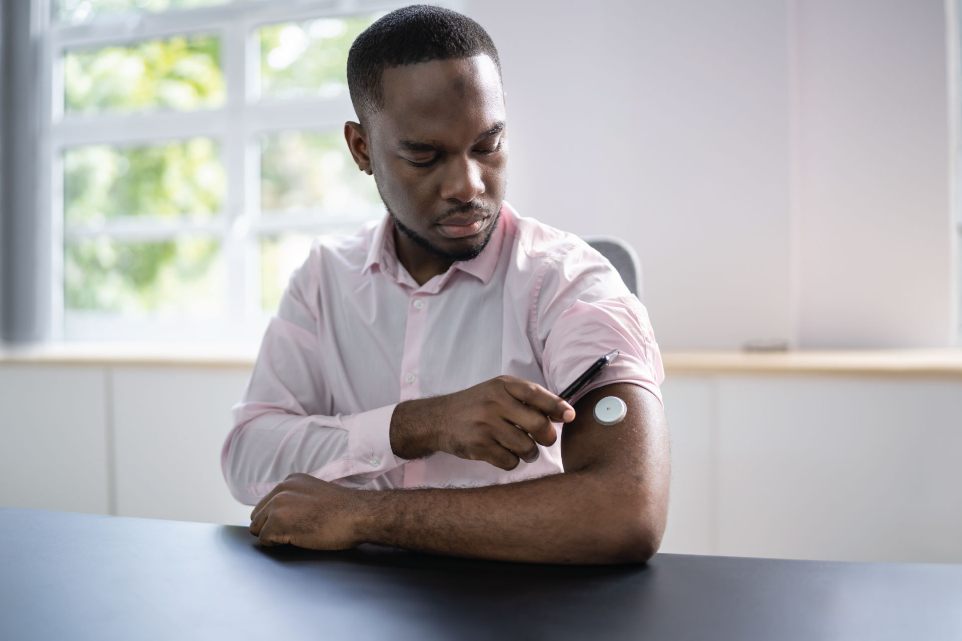 patient checking diabetes monitor