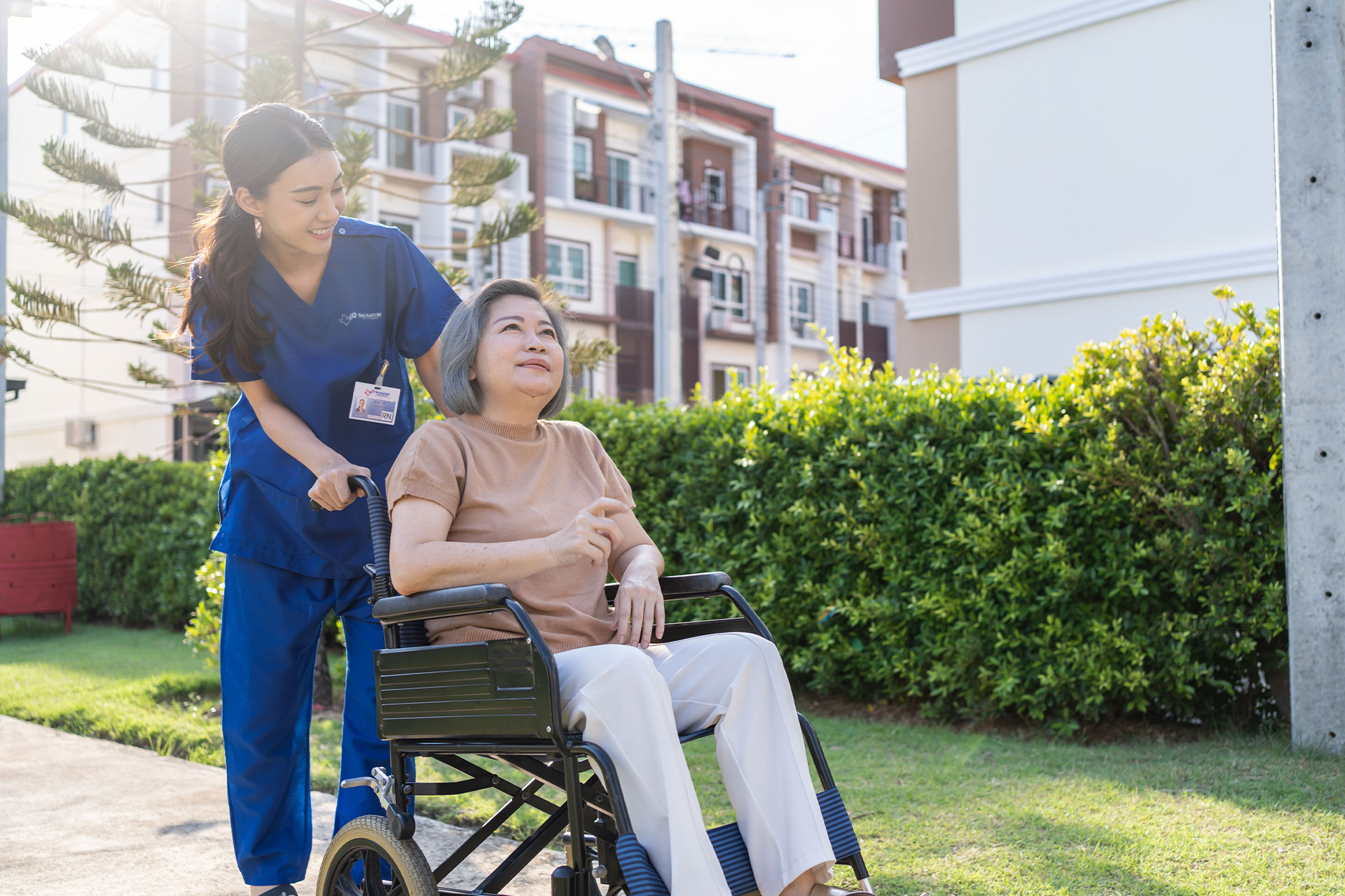 Home nurse taking patient for a walk