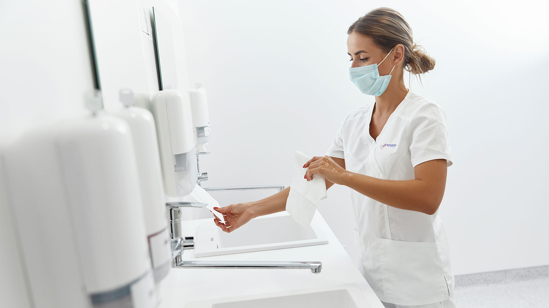 Nurse drying her hands