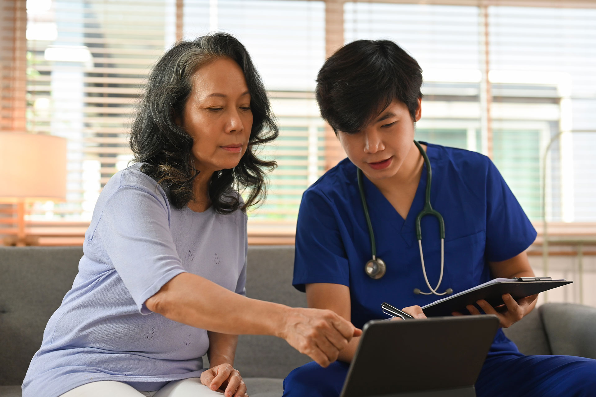 male nurse going over care plan with family member