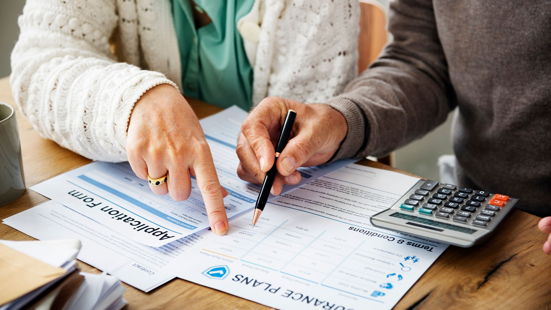 People signing an insurance application