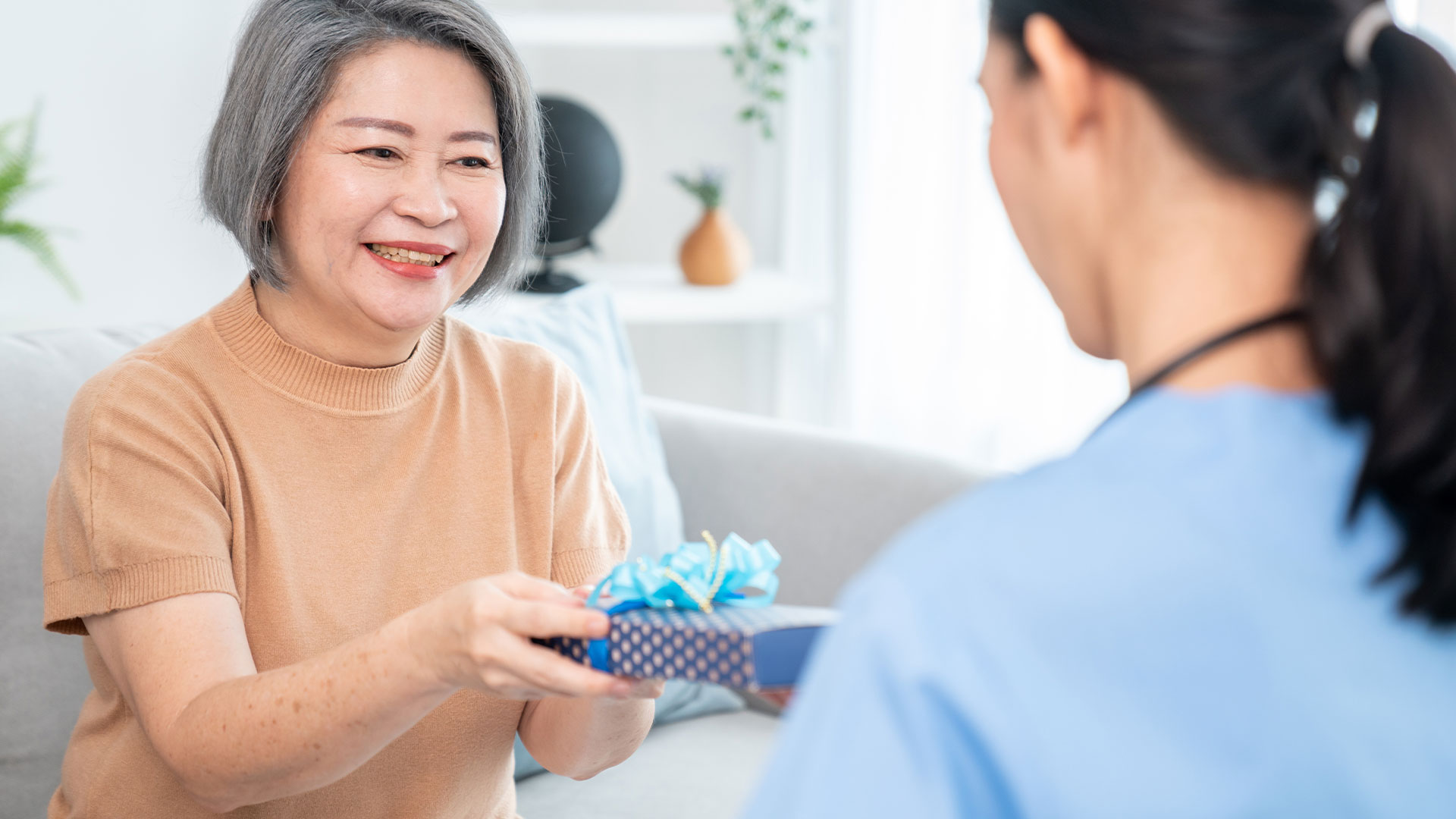 Patient giving a nurse a gift