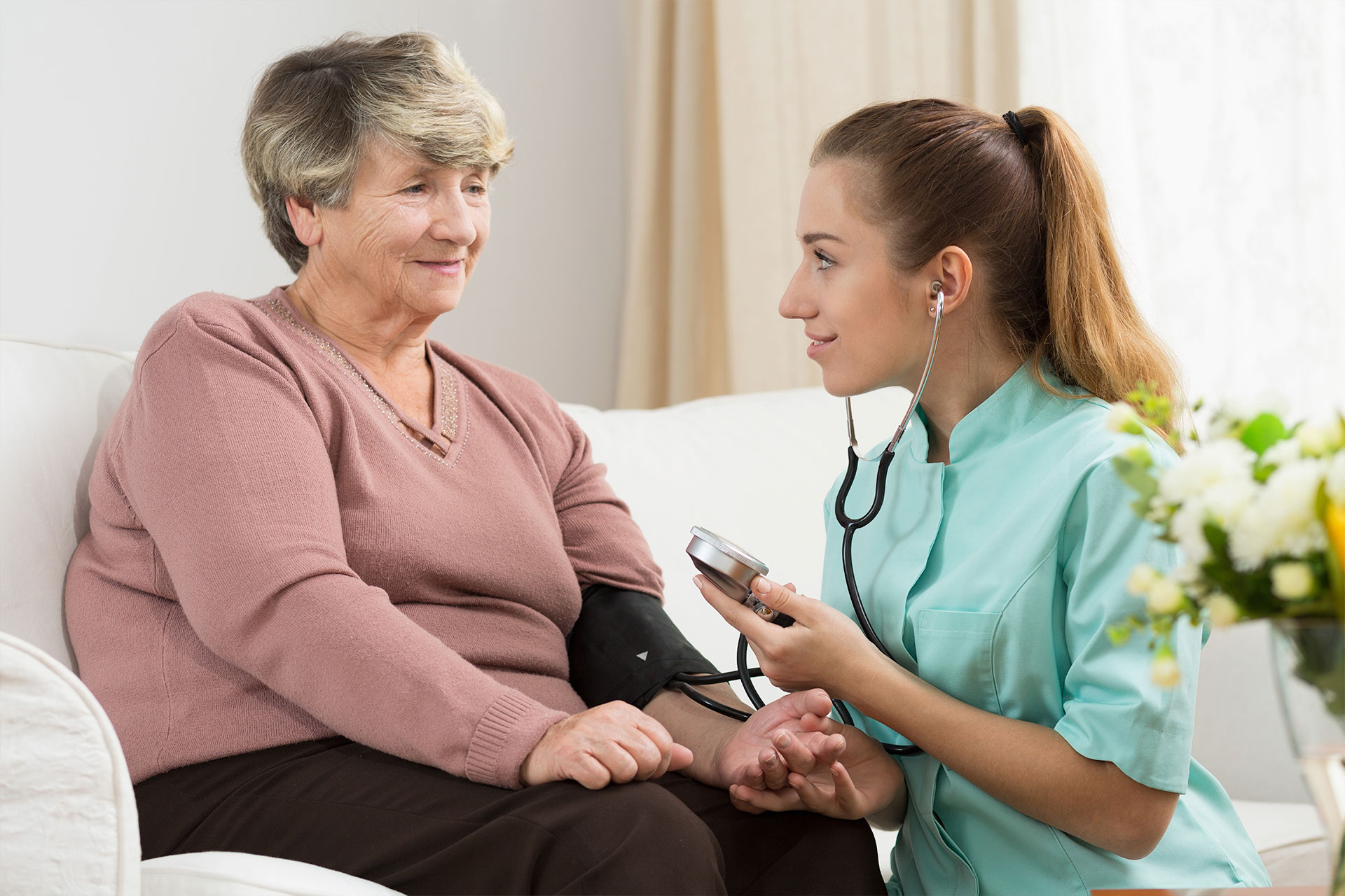 nurse taking patients blood pressure