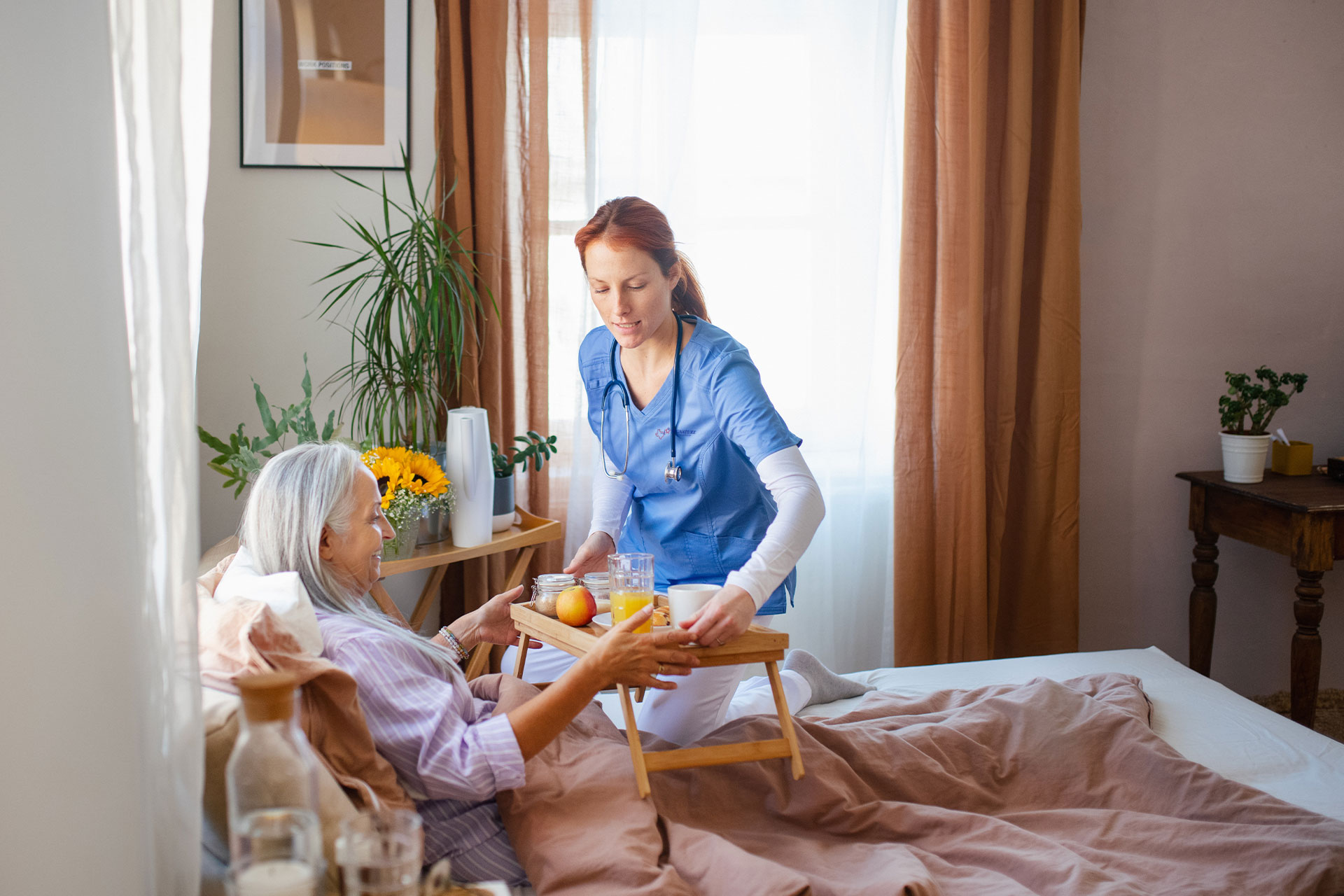 Hero-Nurse-Bring-Food-Patient-Bedbound nurse helping educate patient about medications