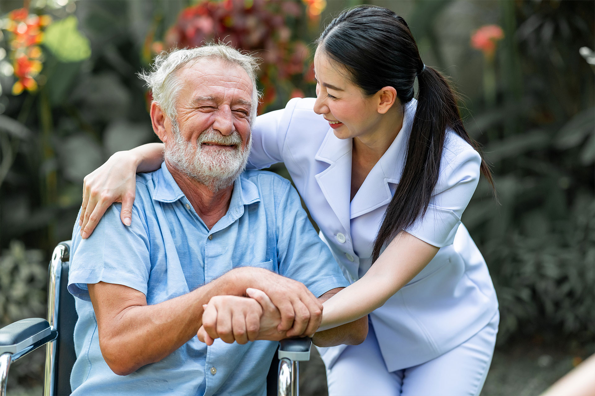 Nurse helping homebound patient in wheelchair outside 