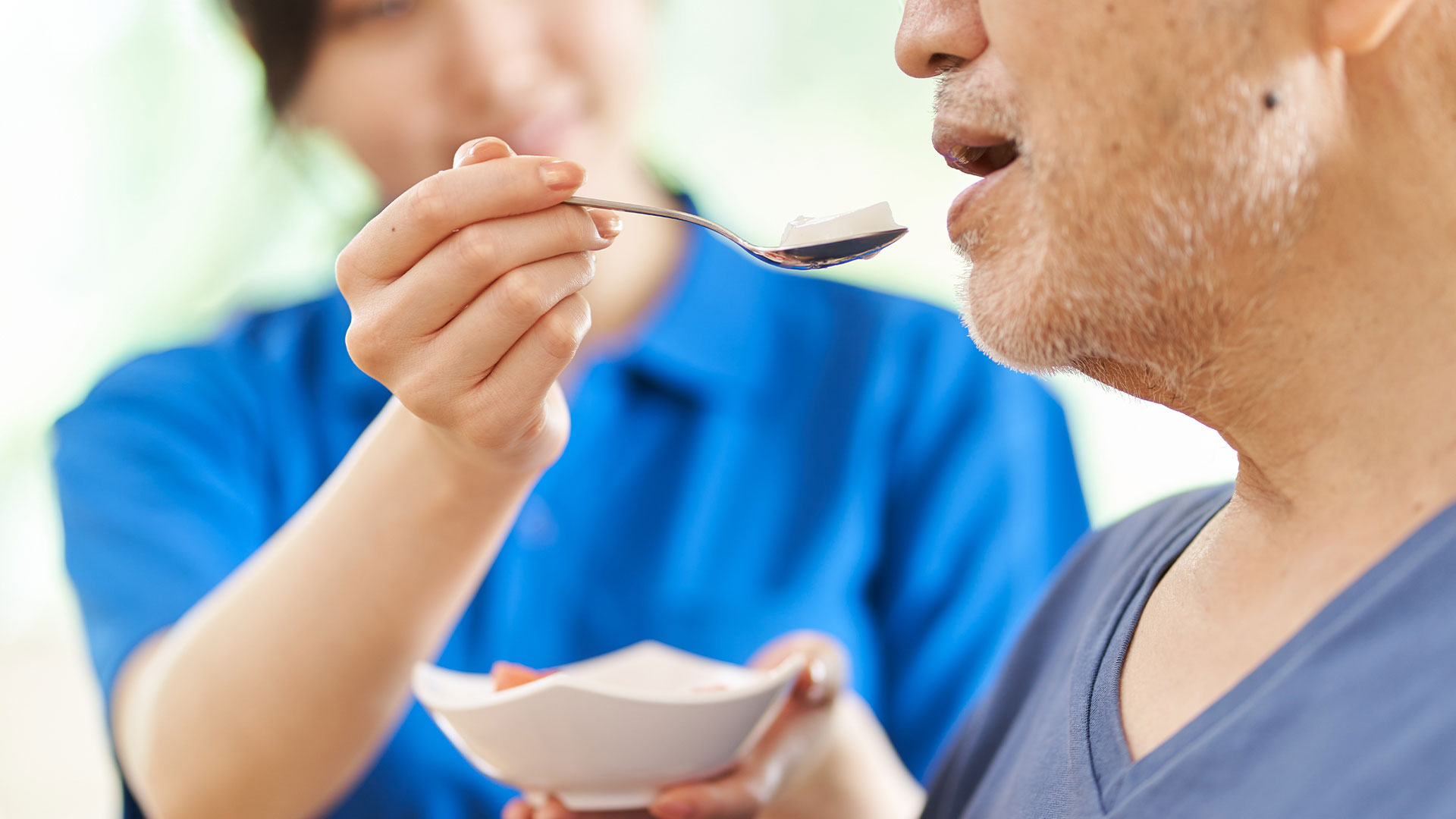 Nurse helping patient eat food